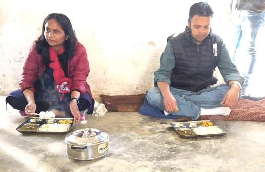 District Magistrate Pithoragarh Reena Joshi taking food with students